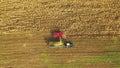 Aerial View Of Rural Landscape. Combine Harvester And Tractor Working In Corn Field. Collects Dry Corn Plants Royalty Free Stock Photo