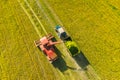 Aerial View Of Rural Landscape. Combine Harvester And Tractor Working Together In Field. Harvesting Of Oilseed In Spring Royalty Free Stock Photo