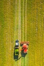 Aerial View Of Rural Landscape. Combine Harvester And Tractor Working Together In Field. Harvesting Of Oilseed In Spring Royalty Free Stock Photo