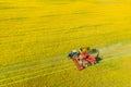 Aerial View Of Rural Landscape. Combine Harvester And Tractor Working Together In Field. Harvesting Of Oilseed In Spring Royalty Free Stock Photo