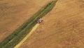 Aerial View Of Rural Landscape. Combine Harvester Working In Field, Collects Seeds. Harvesting Of Wheat In Late Summer Royalty Free Stock Photo