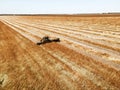 Aerial View Of Rural Landscape. Combine Harvester Working In Field, Collects Seeds. Harvesting Of Wheat In Late Summer. Royalty Free Stock Photo