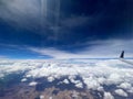 Aerial view of a rural landscape enveloped in puffy clouds in blue sky background Royalty Free Stock Photo