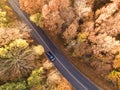 Aerial view of rural road with black car in yellow and orange au Royalty Free Stock Photo