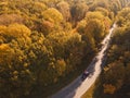 Aerial view of rural road with black car in yellow and orange au Royalty Free Stock Photo