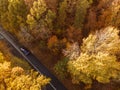 Aerial view of rural road with black car in yellow and orange au Royalty Free Stock Photo