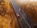 Aerial view of rural road with black car in yellow and orange au Royalty Free Stock Photo