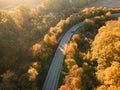 Aerial view of rural road with black car in yellow and orange au Royalty Free Stock Photo