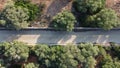 Aerial view of a rural road surrounded by Mediterranean forests at sunset Royalty Free Stock Photo