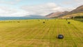 Aerial view of rural traditional house and farm field at small village in Svalbardseyri near Akureyri, Iceland