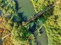 Aerial view of rural wooden bridge over small forest river Royalty Free Stock Photo