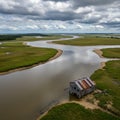 Aerial View of a Rustic House on a River in a Marsh Landscape Royalty Free Stock Photo