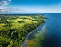 An aerial view of Saaremaa island featuring patchwork fields, forests, and coastal cliffs meeting the Baltic Sea Royalty Free Stock Photo