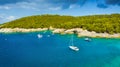 Aerial view on sail yacht, rocks and forest. Sea coastline. Vacation and adventure. Rocks and turquoise water. Top view from drone Royalty Free Stock Photo