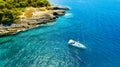 Aerial view on sail yacht, rocks and forest. Sea coastline. Vacation and adventure. Rocks and turquoise water. Royalty Free Stock Photo