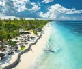 Aerial view of the sailboat on blue sea, empty white sandy beach Royalty Free Stock Photo