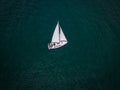 Aerial view of a sailboat gracefully gliding across the boundless waves of the sea. Royalty Free Stock Photo