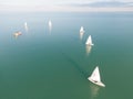 Aerial view of sailboats floating on the sparkling blue ocean