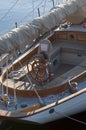 Aerial view of sailing boat. Wooden rudder, white sails