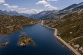 Aerial view of the San Bernardino Pass in the Swiss Alps. Pictured is Moesola Lake and its little islands, with the road skirting Royalty Free Stock Photo