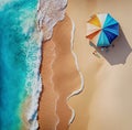 Aerial view of sand beach with green waves and sunshade