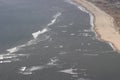 Aerial view of the sand sea beach and shallow water with waves. Royalty Free Stock Photo