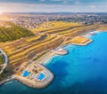 Aerial view of sandy beach, blue sea, restaurants at sunset Royalty Free Stock Photo