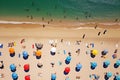 Aerial view of sandy beach with colorful umbrellas, swimming people in sea bay with transparent blue water in summer Royalty Free Stock Photo