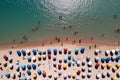 Aerial view of sandy beach with colorful umbrellas, swimming people in sea bay with transparent blue water in summer Royalty Free Stock Photo