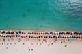 Aerial view of sandy beach with colorful umbrellas, swimming people in sea bay with transparent blue water in summer Royalty Free Stock Photo