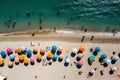 Aerial view of sandy beach with colorful umbrellas, swimming people in sea bay with transparent blue water in summer Royalty Free Stock Photo