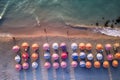 Aerial view of sandy beach with colorful umbrellas, swimming people in sea bay with transparent blue water in summer Royalty Free Stock Photo