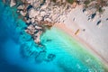 Aerial view of sandy beach with couple and canoe and blue sea Royalty Free Stock Photo