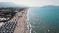 Aerial view of a sandy beach full of sunbeds and the Aegan sea, Crete, Greece