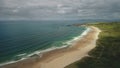 Aerial view sandy beach: ocean foamy waves drops to coastline in White Beach, Antrim County Royalty Free Stock Photo