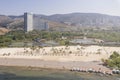 Aerial view of sandy beach with palm trees in Fuxian Lake coast with boats, Yunnan - China