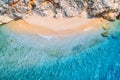 Aerial view of sandy beach with rocks and sea with blue water Royalty Free Stock Photo