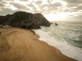 Aerial view from a sandy beach at the sunset with an amazing cliff