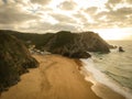 Aerial view from a sandy beach at the sunset with an amazing cliff Royalty Free Stock Photo