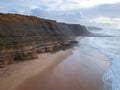 Aerial view from a sandy beach at the sunset with an amazing cliff Royalty Free Stock Photo