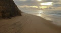 Aerial view from a couple walking sandy beach at the sunset with an amazing cliff Royalty Free Stock Photo