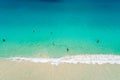 Aerial view of sandy beach with tourists swimming in beautiful clear sea water Royalty Free Stock Photo