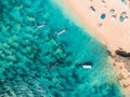 Aerial view of sandy beach with turquoise sea water and local boats, drone shot Royalty Free Stock Photo