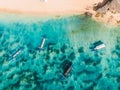 Aerial view of sandy beach with turquoise sea water and local tradition boats in Bali Royalty Free Stock Photo