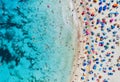 Aerial view of sandy beach with umbrellas and sea