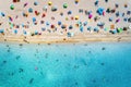 Aerial view of sandy beach with umbrellas and sea