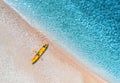 Aerial view of sandy beach with yellow canoe and blue sea Royalty Free Stock Photo