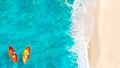 Aerial View of Sandy Tropical Beach and Ocean with Two Colorful Boats Floating on Turquoise Water Royalty Free Stock Photo