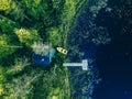 Aerial view of Sauna house by the lake shore.  Wooden pier with fishing boat Royalty Free Stock Photo