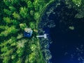 Aerial view of Sauna house by the lake shore.  Wooden pier with fishing boat Royalty Free Stock Photo